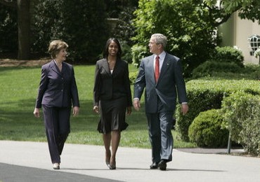 President George W. Bush and Mrs. Laura Bush accompany 2006 National Teacher of the Year Kim Oliver to the South Lawn ceremony in her honor Wednesday, April 26, 2006. Said the President of the Silver Spring, Maryland kindergarten teacher, "Kim Oliver understands that the key to helping children succeed is fighting the soft bigotry of low expectations." White House photo by Paul Morse